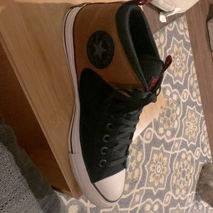 These are brown and black mountain boat inspired converse